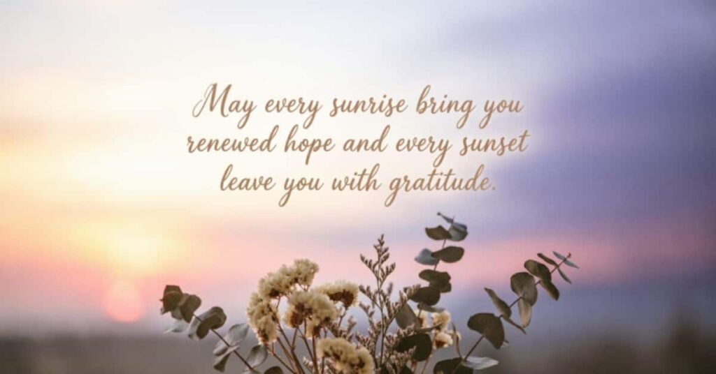 Heartfelt birthday message wishing renewed hope with every sunrise and gratitude with every sunset, set against a peaceful pastel sky with delicate flowers and leafy branches.