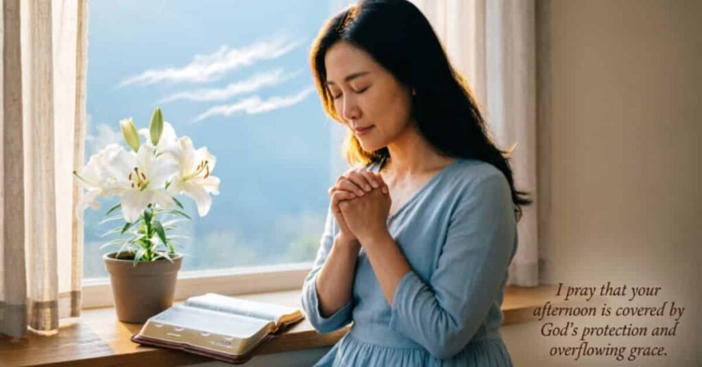 Woman praying near a window next to an open Bible and white lilies with uplifting Christian afternoon prayer quote
